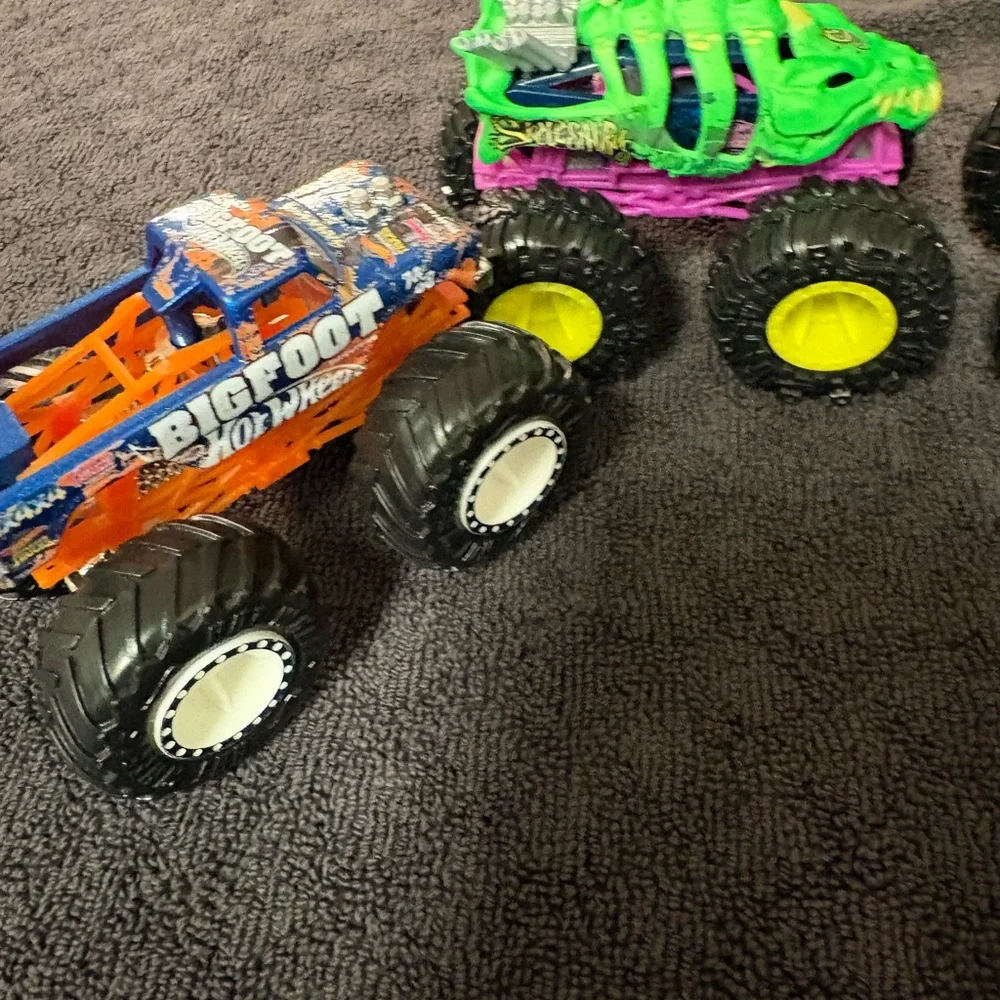 Hot Wheels 4 lot of Monster Truck Toys. Assorted Colors (Green, Orange, Blue)